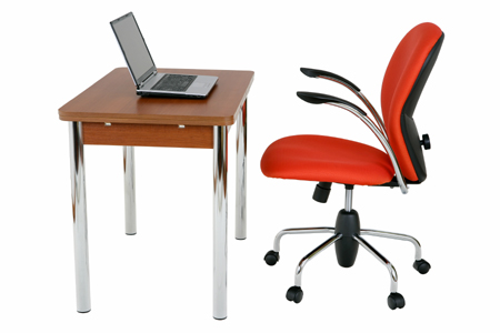 Empty chair at a desk with a laptop on