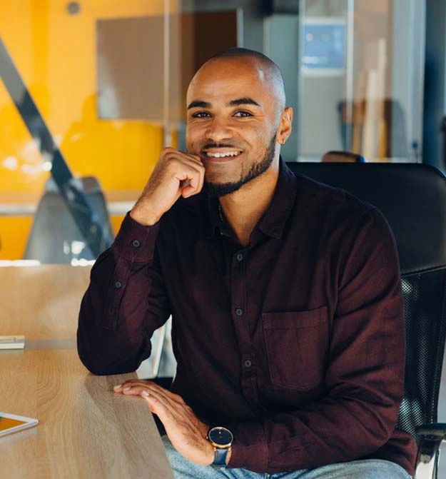 Man Smiling At Desk After Using Zetadocs On Business Central In The Cloud For AP Automation