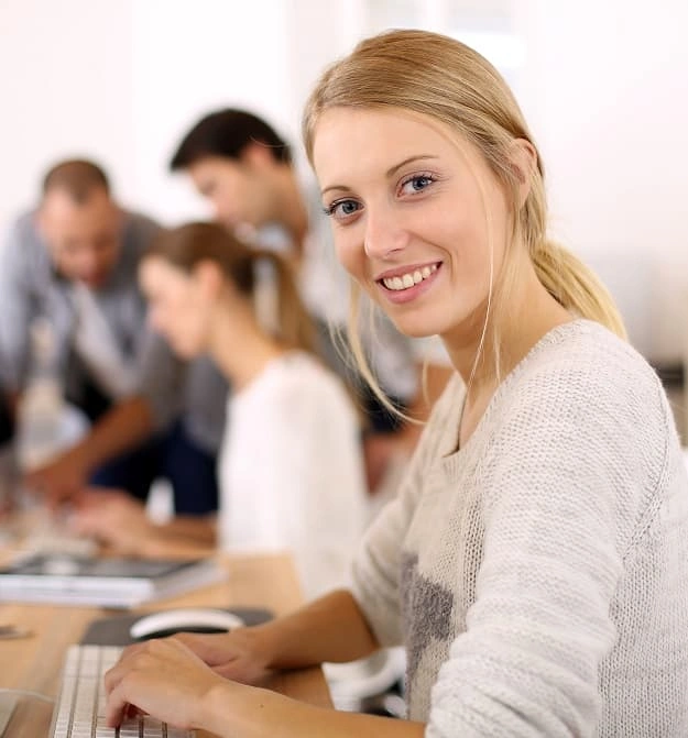 Lady at desk, happy after using Zetadocs Expenses Express expense management software on Business Central and NAV