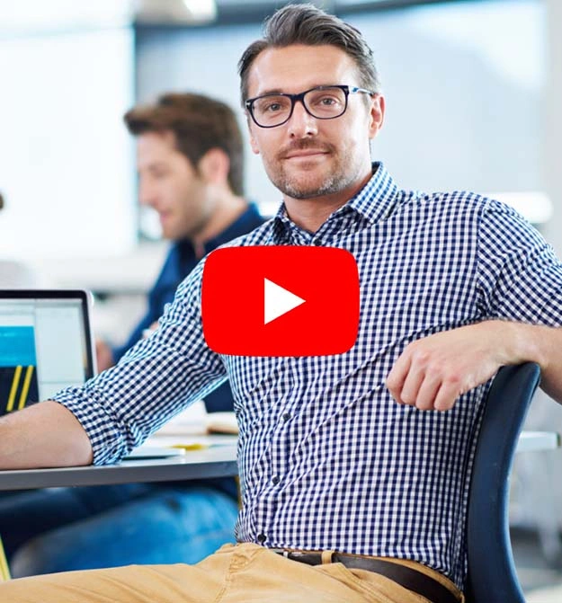 Male Sat At His Desk, Smiling After Using Business Central Document Management Software Zetadocs