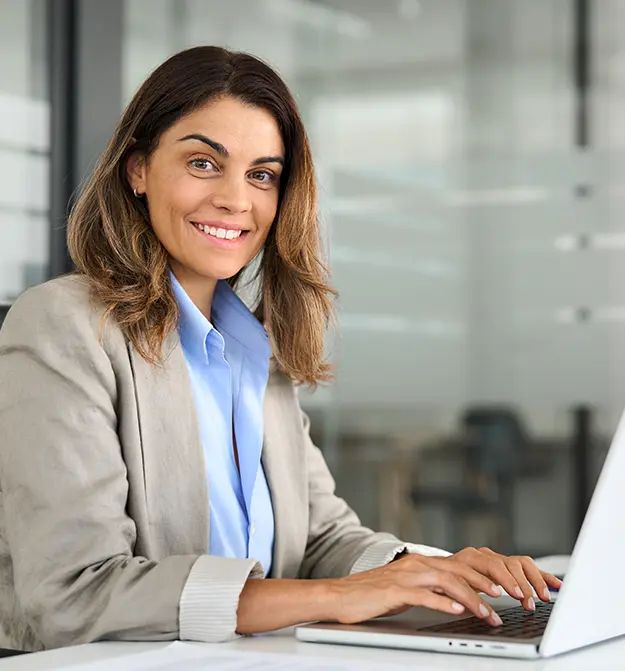 Women Smiling At Her Desk Using Zetadocs Journal Document Processing on Business Central
